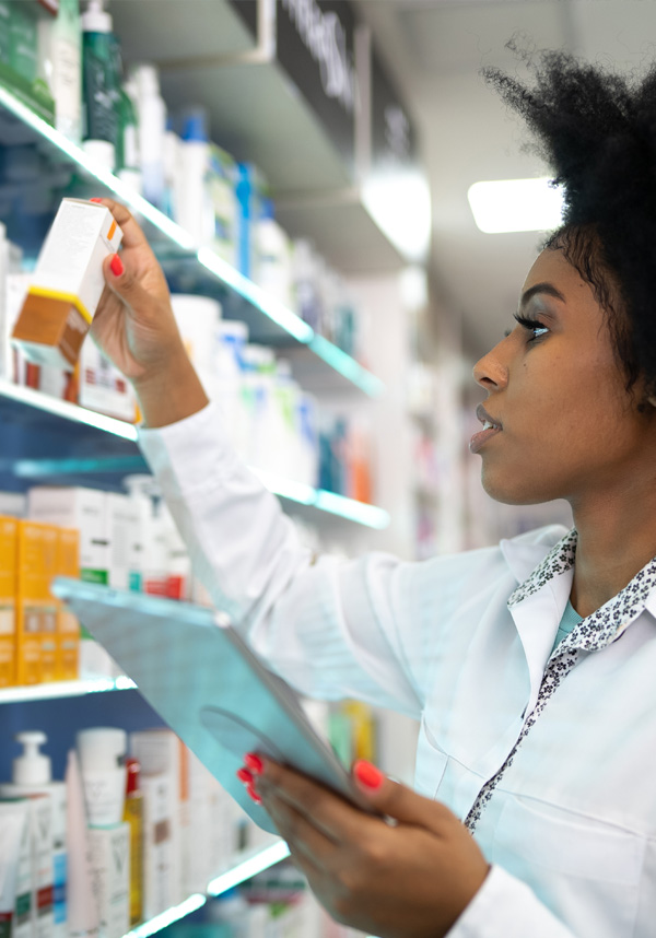 A provider taking stock of prescription bottles on a shelf