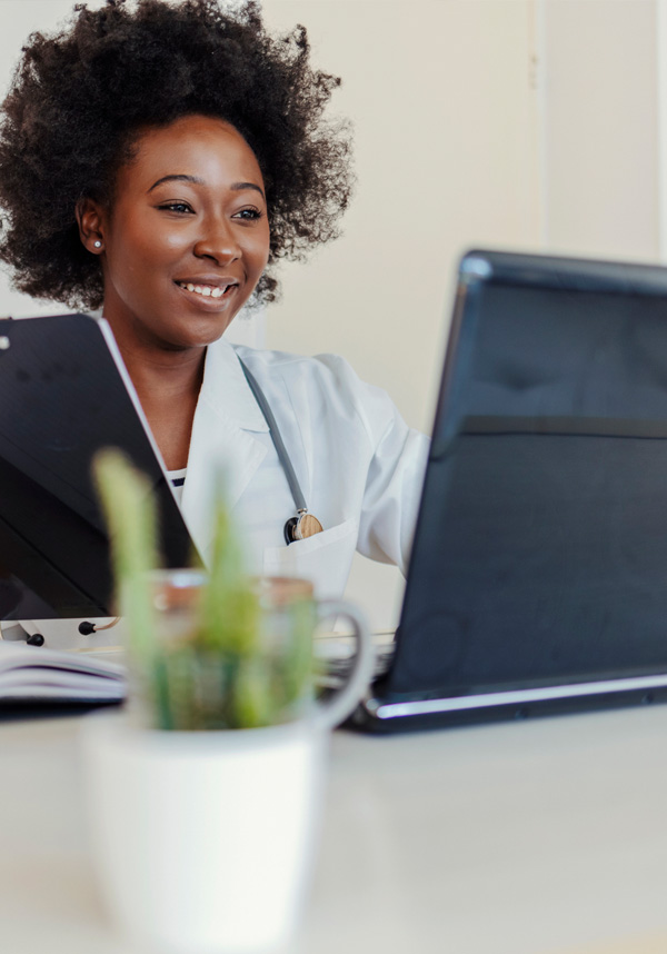 A provider giving telehealth services over a laptop.