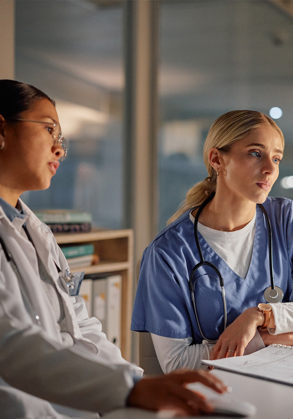 Two providers utilizing training resources in a lab setting.